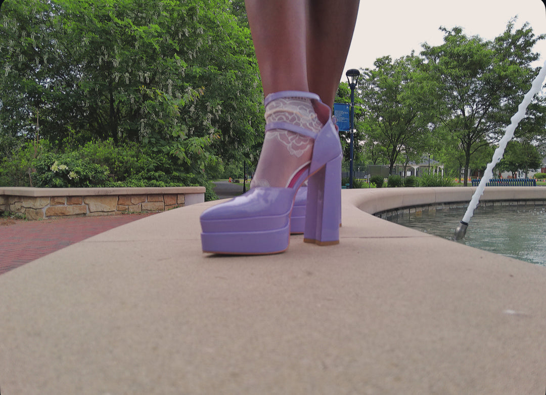 Side view of white lace ankle socks with delicate trim, styled with open-toe heels – feminine fashion accessory