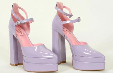 Lavender platform heels, diagonal front view angled to showcase side profile, front straps, and platform height, displayed on a white backgrou